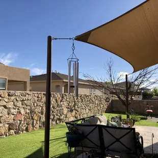 a patio area with a stone wall