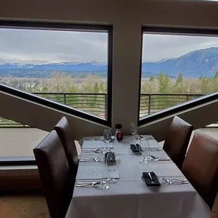 a dining room with a view of the mountains