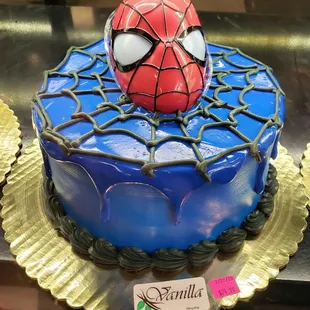 a spider - man cake on display