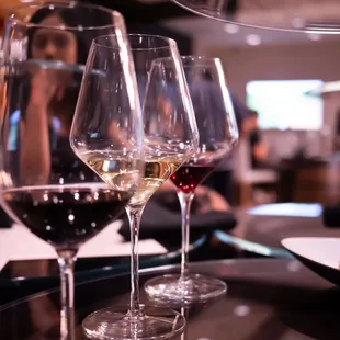 three glasses of wine on a table