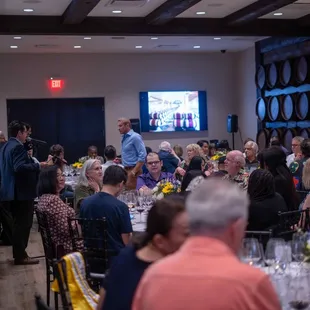 a large group of people sitting at tables