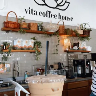 a hand holding a cup of coffee