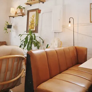 a leather couch and a wooden chair