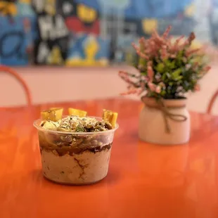 an orange table with a cup of ice cream