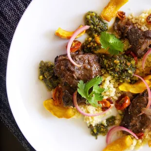 braised beef with delicata squash, millet, roasted cherry tomato + pickled onion