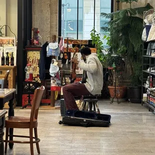 a man sitting on a chair in a store