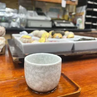a cup of tea on a wooden tray