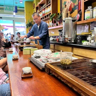 a man serving a meal to a group of people