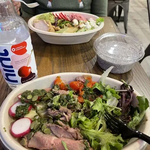 Chimmichurri steak &amp; roasted potato bowl in front, supergreen goddess salad behind, chia pudding on the right.