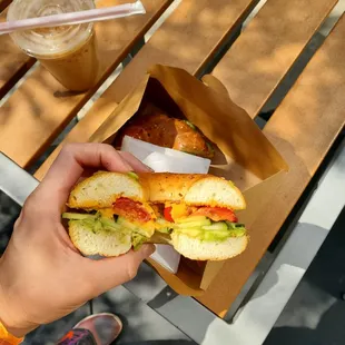 Bagel sandwich with roasted pepper hummus, avocado, cucumber, and grape tomatoes... so good!