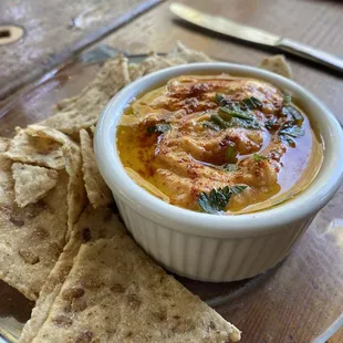 a bowl of hummus and tortillas