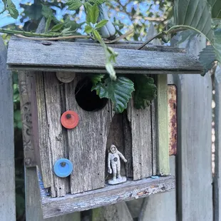 a birdhouse with a figurine in it