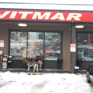 two cars parked in front of a store