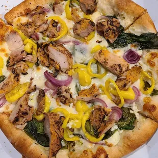 White Pizza with spinach, onion, banana pepper, and chicken added.