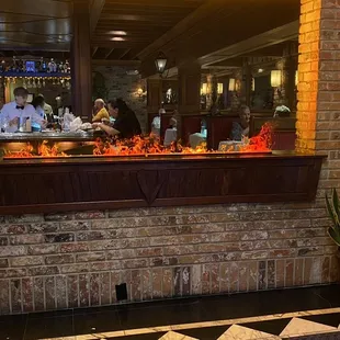 a brick bar with a black and white checkered floor