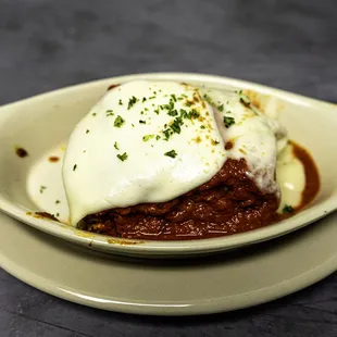 Vito's Signature Meat Lasagna with creamy ricotta cheese layered with pasta sheets and topped with mozzarella and red sauce.