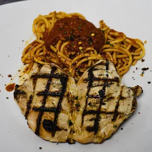 Chicken Diavolo, grilled chicken breast served over a bed of spaghetti pasta with a spicy red sauce