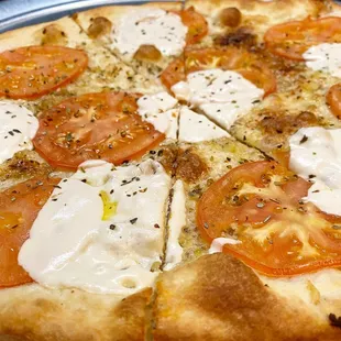 a pizza with tomatoes and mozzarella