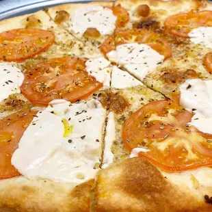 a pizza with tomatoes and mozzarella