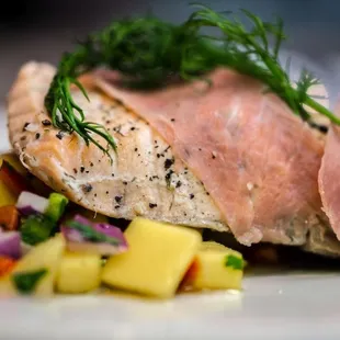 a piece of salmon on a white plate