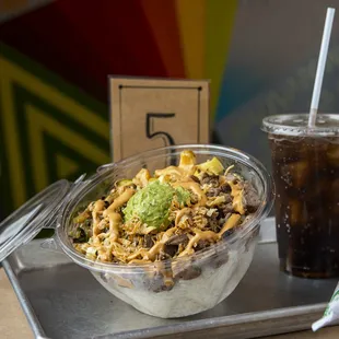 a bowl of noodles and a drink