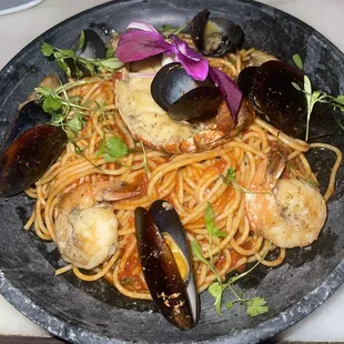 Lobster tail, mussels, shrimp over a tomato pasta base.