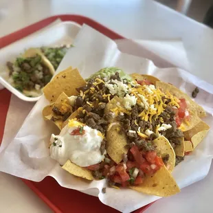 a plate of nachos and a bowl of salsa