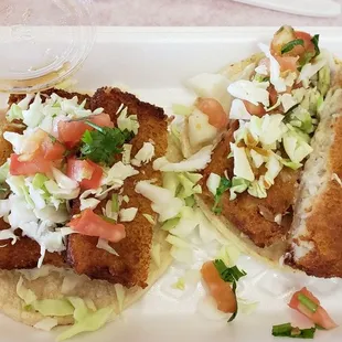 two tacos on a red tray