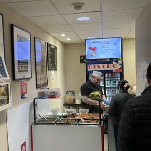 a man serving food to a woman