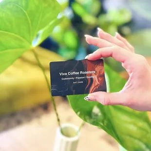 a person holding a coffee roaster card