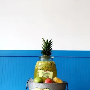 a fish and a pineapple in a bucket