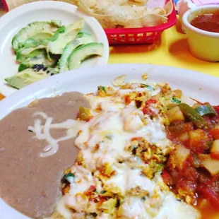 Breakfast ... the most important meal of the day, make it count!!! Chilaquiles for me with fresh avocado slices.