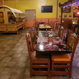 a dining area with tables and chairs