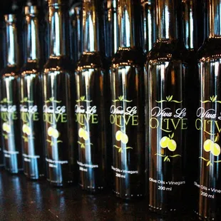 a row of bottles of olive juice