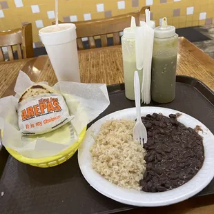 An Arepa with a side of rice &amp; beans and a passion fruit drink