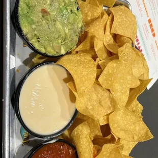 Chips salsa, guacamole and queso