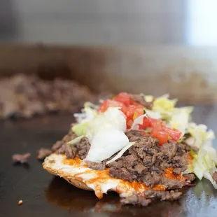 a hamburger sandwich with lettuce, tomato, and cheese