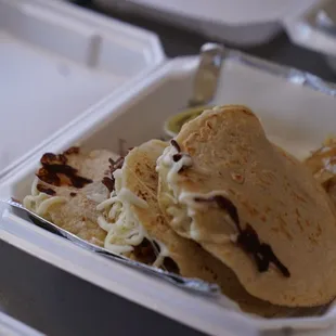 a plate of food in a styrofoam container