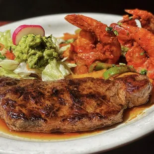 Our delicious Tierra y Mar...juicy carne asada grilled to taste served with jumbo shrimp, ranchero style