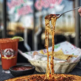 Queso fondido with chorizo served with a delicious michelada