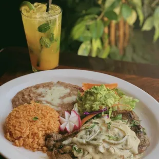 Carne Asada Rajas y Crema paired with a mango Mojito