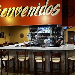 a woman sitting at a bar