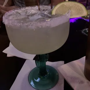 a margarita with a lime slice on the rim