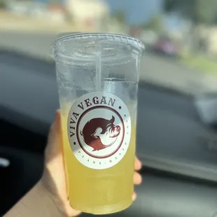 a person holding a drink in their hand