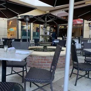 an outdoor dining area with tables and chairs