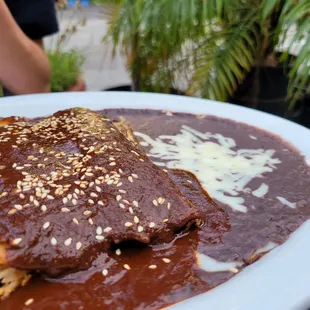 a plate of enchiladas and rice