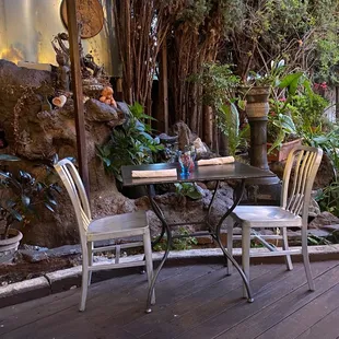 a patio with a table and chairs