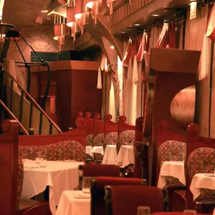 the interior of a restaurant with tables and chairs