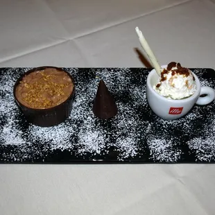 two desserts on a black tray