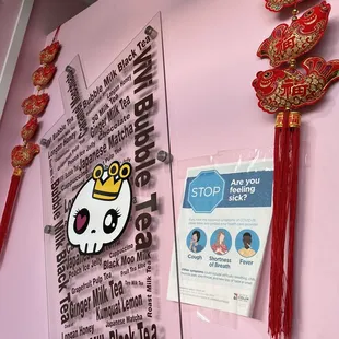 a pink refrigerator with a hello kitty sticker on it